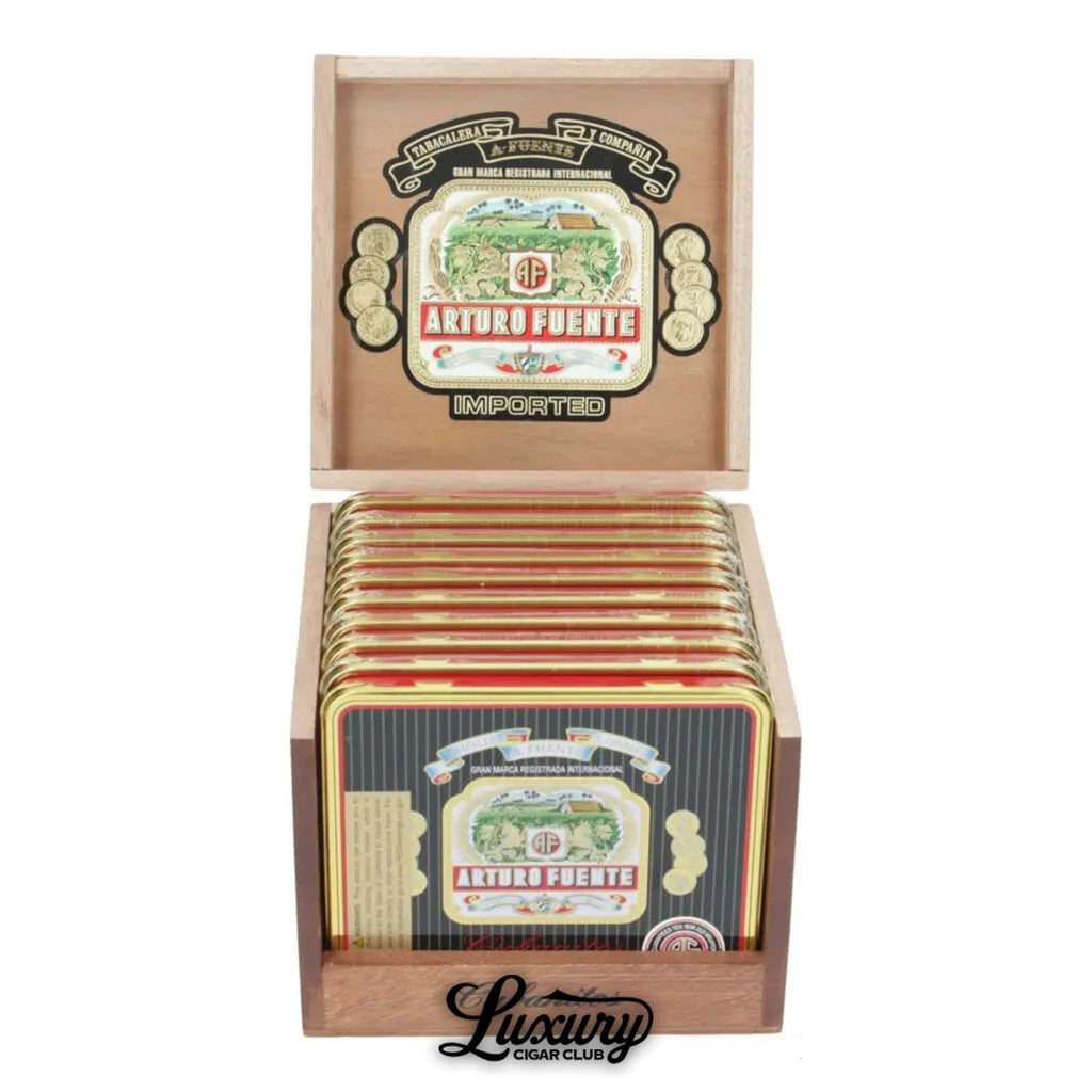 Open wooden display box of Arturo Fuente Cubanitos cigars, showing multiple decorative metal tins with the classic Fuente logo, marked “Imported,” and branded with Luxury Cigar Club below.