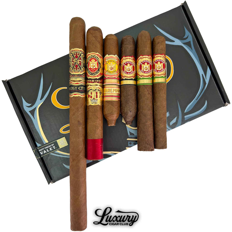 Close-up of Arturo Fuente Don Carlos 90th Dos Capas cigar sampler from Luxury Cigar Club highlighting six handcrafted cigars with detailed Fuente bands and elegant packaging.