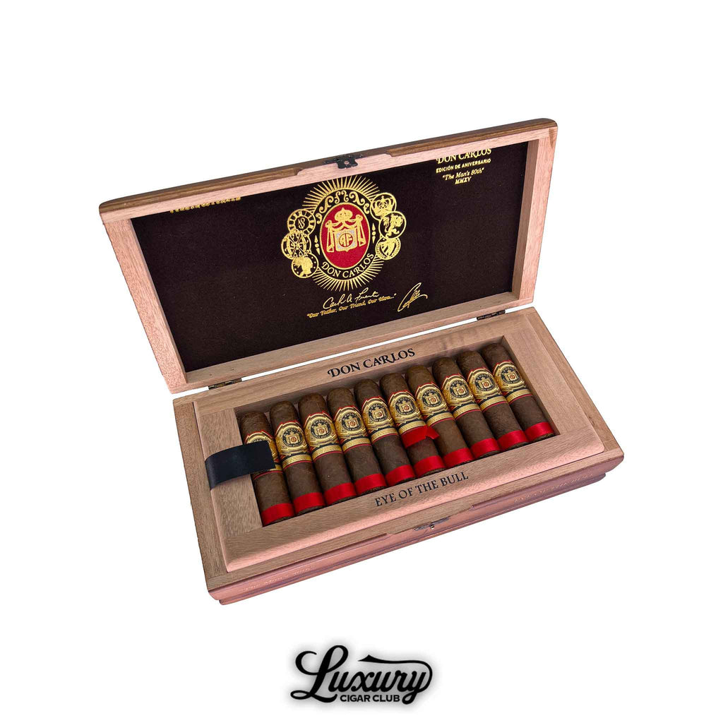Open wooden box of Arturo Fuente Don Carlos Eye of the Bull cigars with gold and red bands presented by Luxury Cigar Club.