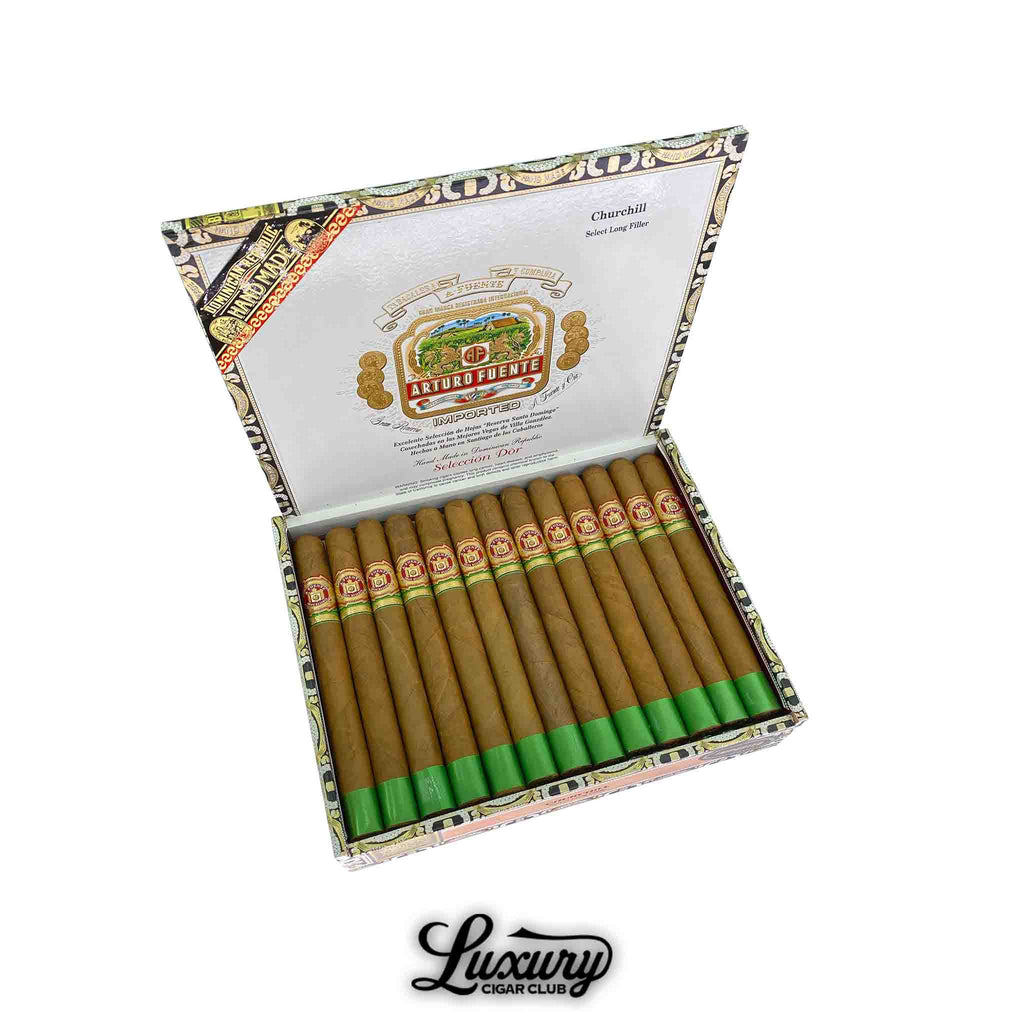 Open box of Arturo Fuente Gran Reserva Churchill Selección d’Oro Natural cigars, featuring 25 cigars with green foot bands, displayed in a decorative box with the Arturo Fuente crest and “Luxury Cigar Club” logo beneath.