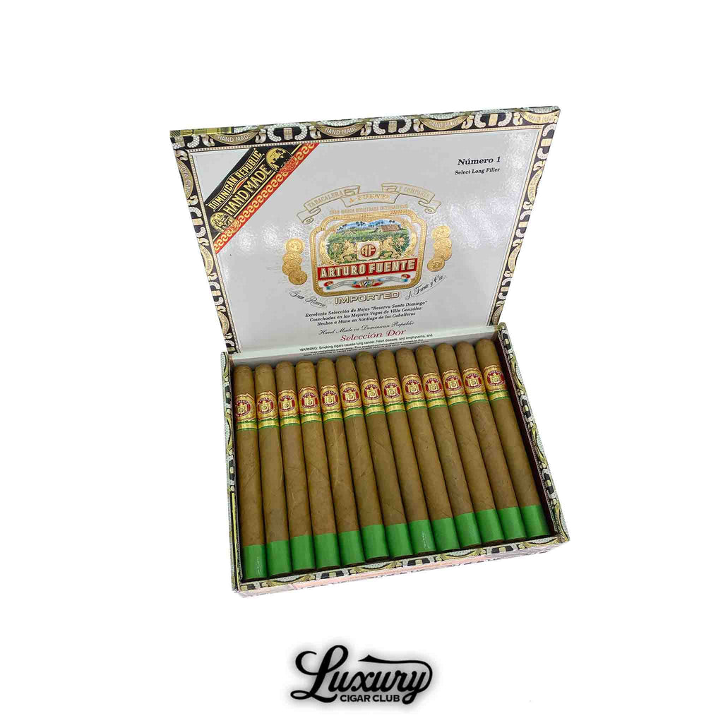 Open box of 25 Arturo Fuente Gran Reserva Selección Privada No 1 Selección d’Oro Natural cigars, each with a green foot band and red Fuente band, displayed in an ornate box with the Arturo Fuente crest and “Luxury Cigar Club” logo below.