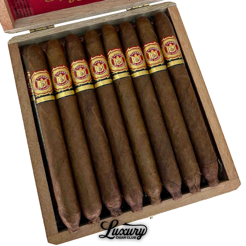 Close-up view of Arturo Fuente Hemingway Classic cigars neatly arranged in an open wooden box, showcasing their torpedo shape, rich brown wrappers, and detailed red and gold bands, with a “Luxury Cigar Club” logo at the bottom.