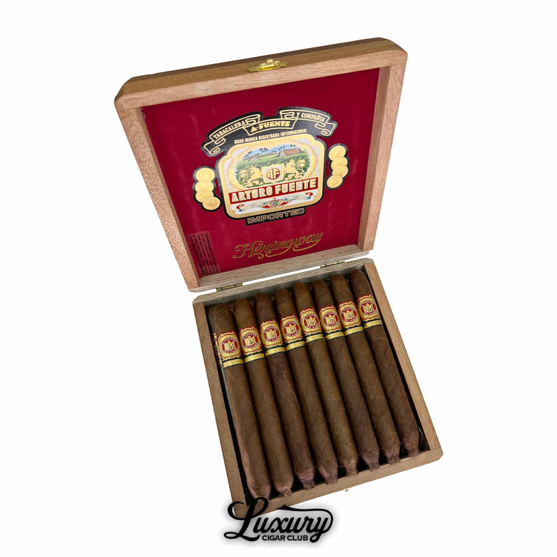 Open wooden box of Arturo Fuente Hemingway Classic cigars, featuring a red interior lid with the Arturo Fuente logo and ten torpedo-shaped cigars neatly arranged inside, with a “Luxury Cigar Club” logo at the bottom.