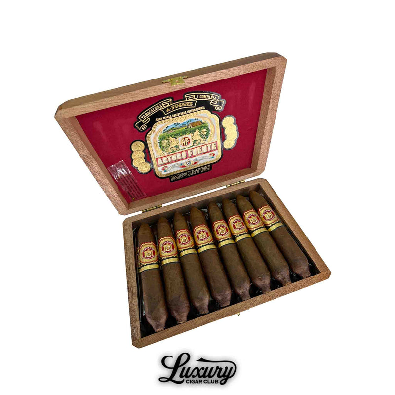 Open box of Arturo Fuente Hemingway Work of Art cigars featuring a vibrant red interior lid with the Arturo Fuente logo, showcasing ten short, tapered cigars with red and gold bands, displayed above a “Luxury Cigar Club” logo.