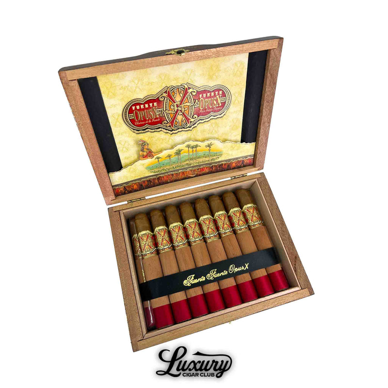 Open box of Arturo Fuente Opus X Limited Edition Double Robusto cigars, featuring cedar-wrapped cigars with red foot bands and ornate gold and red bands, displayed inside a luxury wooden box with branded inner lid.