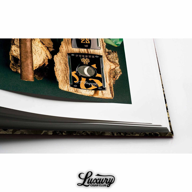 Artistic close-up of a page corner showing Opus X accessories including lighter and cutter – from Arturo Fuente’s “Since 1912” book.