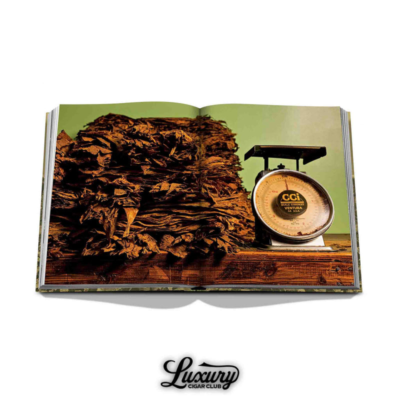 Tobacco leaves and a vintage scale shown inside Arturo Fuente’s collectible book – highlighting traditional cigar craftsmanship.