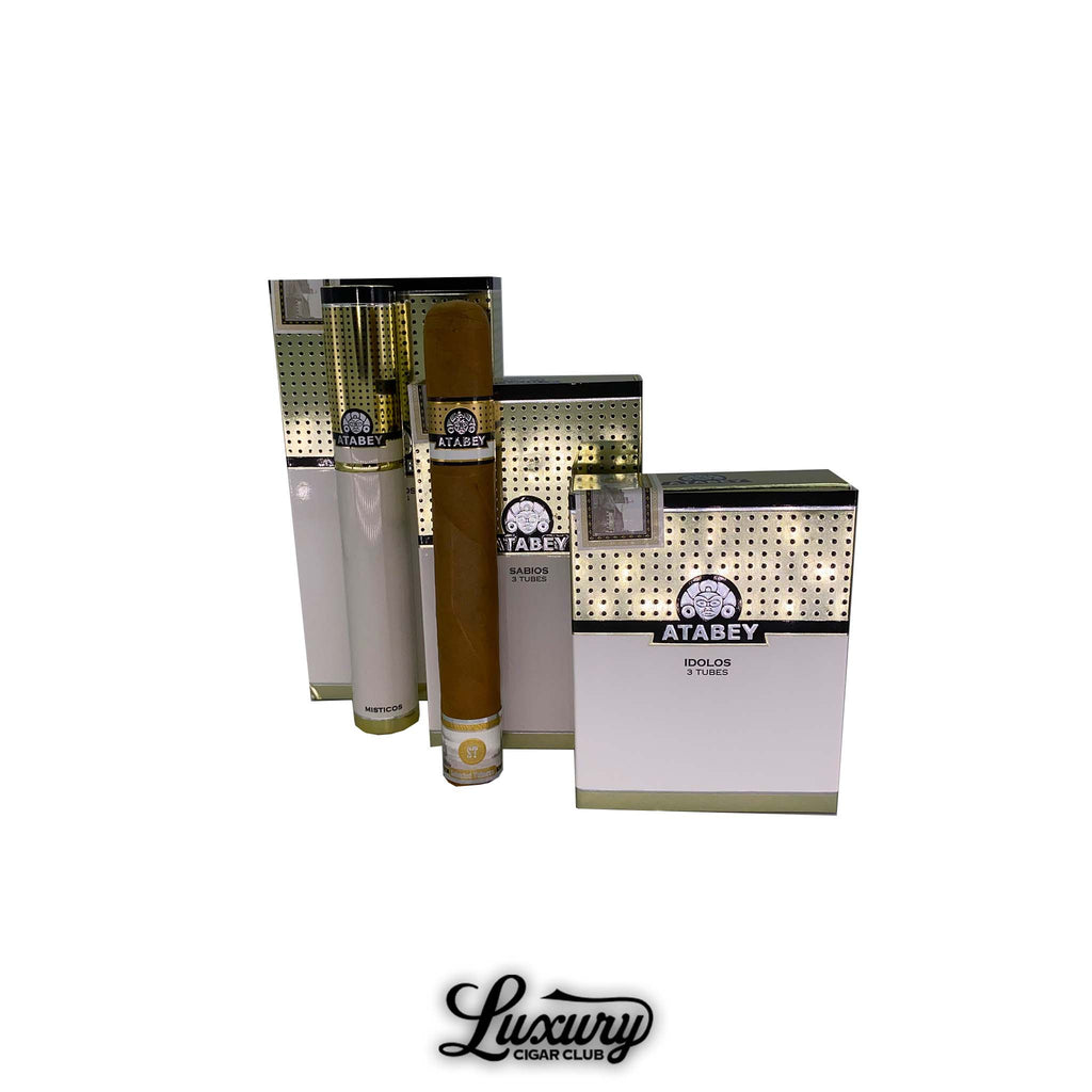 Atabey 3-pack tubos cigars displayed in luxurious white and gold boxes with individual cigars encased in sleek branded tubes.