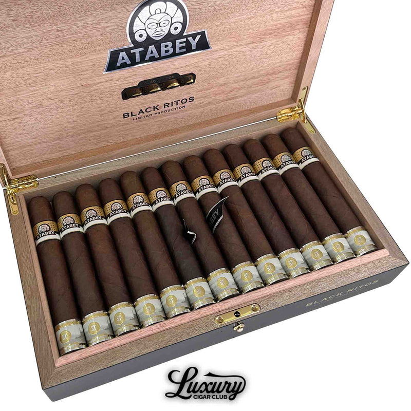 Close-up of Atabey Black Ritos cigars neatly arranged in a wooden box, featuring black and gold bands with the Atabey logo and “Limited Production” text on the inner lid.