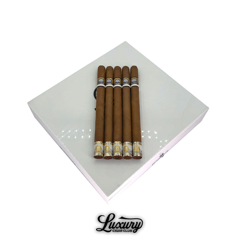 Five Atabey Spiritus cigars displayed on a white Atabey box, featuring long, slim vitolas with flawless golden-tinted wrappers, by Luxury Cigar Club.
