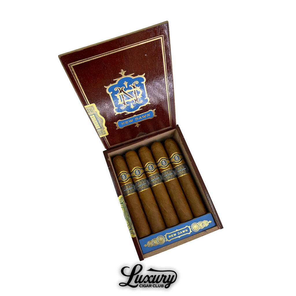 Wooden box of Avowed New Dawn Robusto Grande cigars, neatly arranged with golden-brown wrappers and decorative blue and gold bands, shown at Luxury Cigar Club.