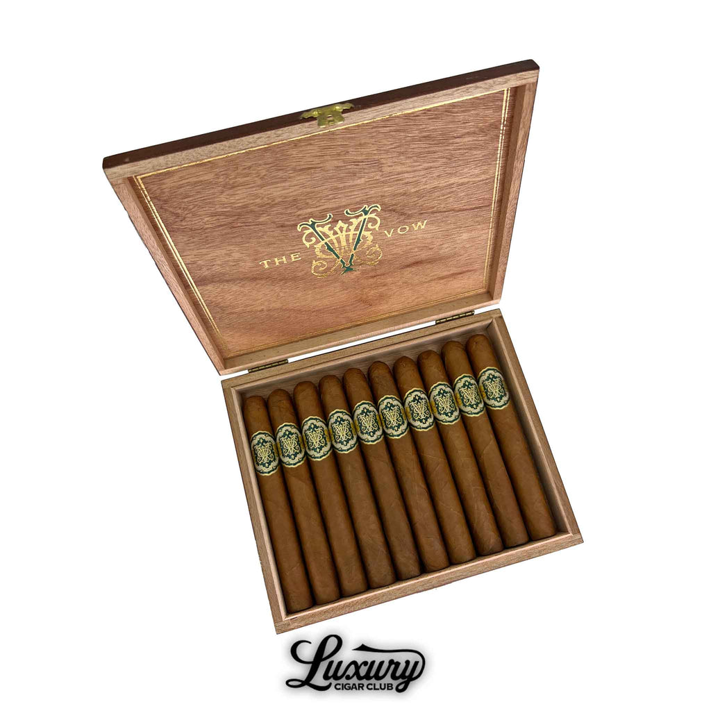 Open box of Avowed The Vow Corona Gorda cigars with golden and green bands, displayed at Luxury Cigar Club.