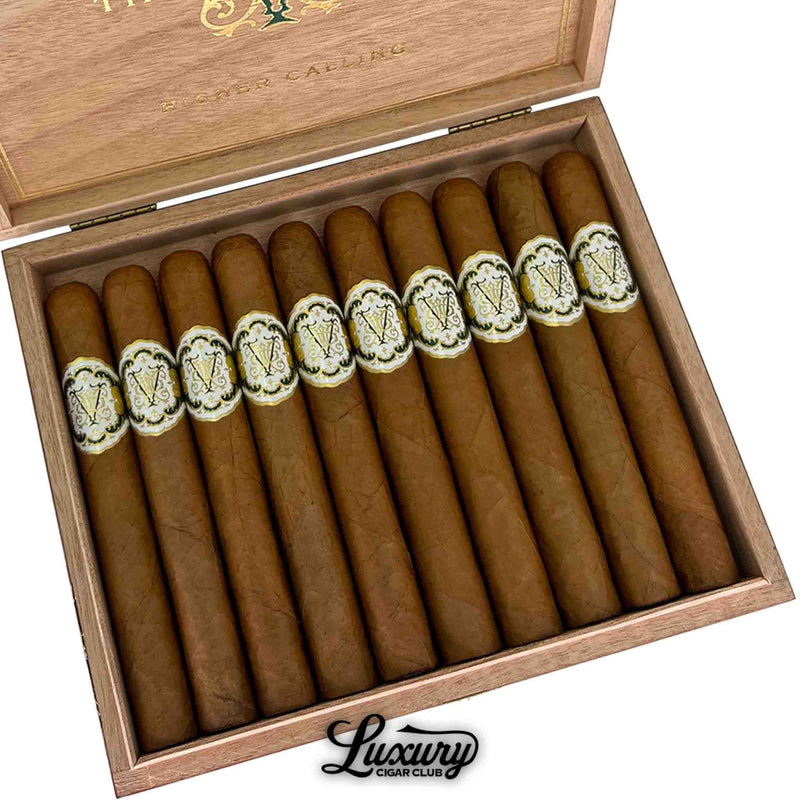 Close-up view of Avowed The Vow Higher Calling Toro cigars in a cedar box, showcasing the intricate gold and white cigar bands.