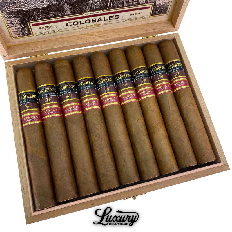 Close-up view of Bandolero Serie C Colosales cigars in box, highlighting the rich wrapper leaves and detailed dual bands marked Serie C, arranged neatly in rows, Luxury Cigar Club branding visible.