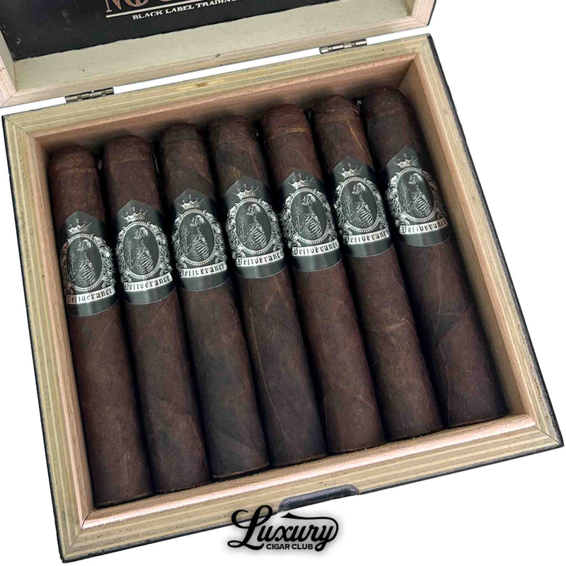Close up of Black Label Trading Co. Deliverance Nocturne Robusto cigars inside the open box from Luxury Cigar Club showcasing dark maduro leaf and ornate silver labels.