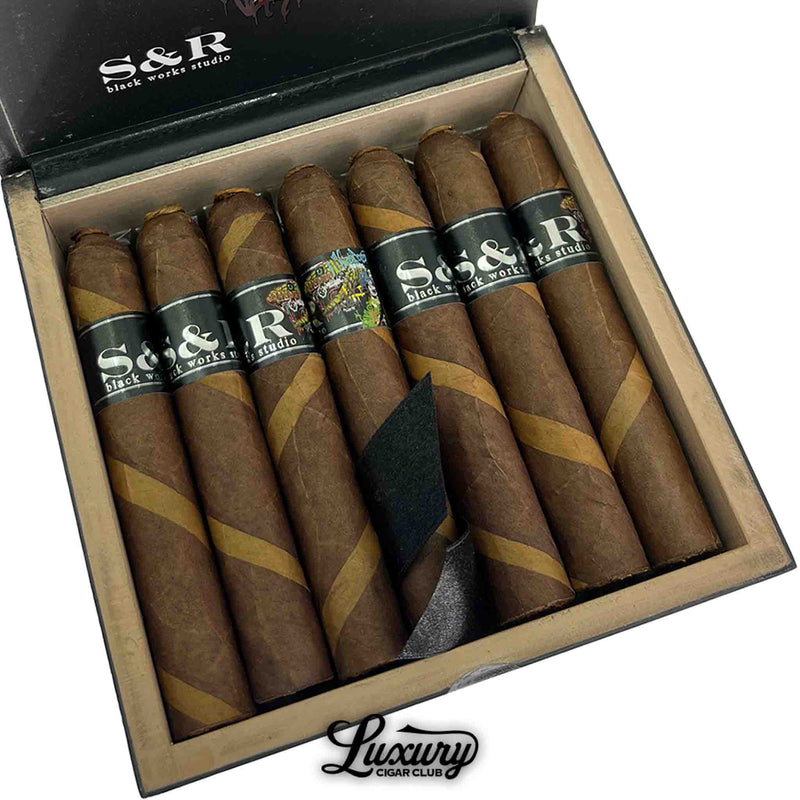 Close-up of Black Works Studio S&R Limited Edition Robusto cigars showing intricate dual-wrapper craftsmanship and signature black bands, featured by Luxury Cigar Club.