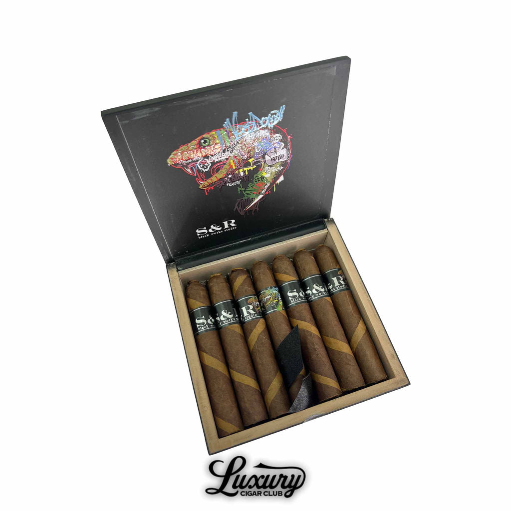 Black Works Studio S&R Limited Edition Robusto cigars showcased in a sleek black box with artistic reptile design, highlighted by Luxury Cigar Club.