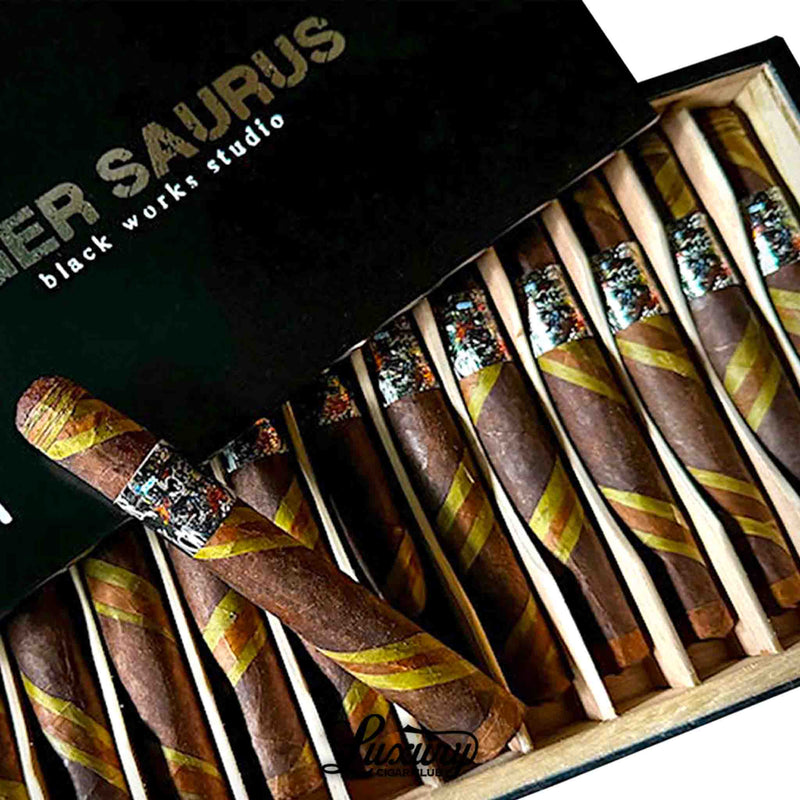Detailed view of Black Works Studio Tigersaurus Corona Gorda cigars featuring unique barber pole wrappers and artistic bands, highlighted by Luxury Cigar Club.