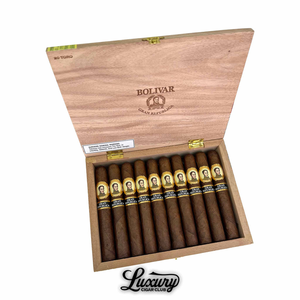 Open wooden box of Bolivar Gran Republica Toro cigars, showing neatly arranged brown cigars with gold and black bands featuring the Bolivar portrait, premium presentation by Luxury Cigar Club.