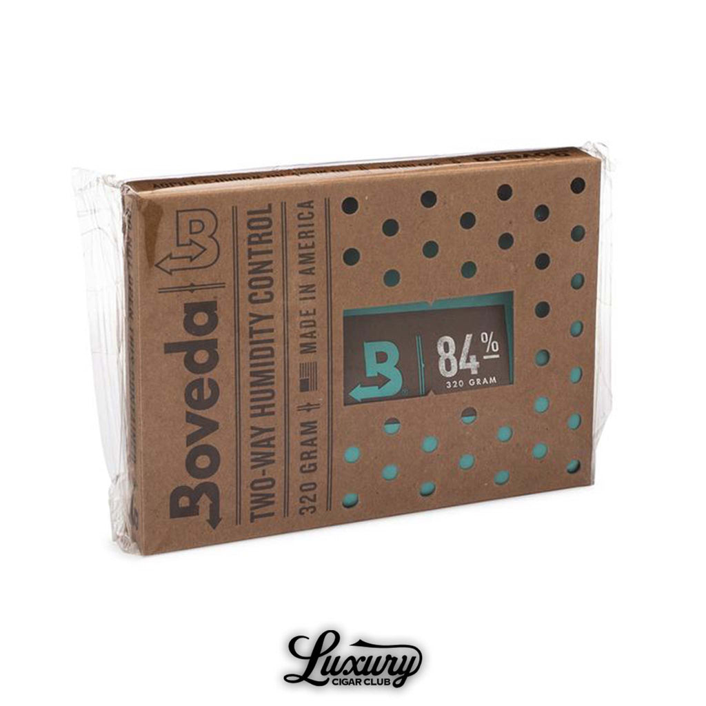 Boveda 320 gram two-way humidity control pack for cigars, 84% RH level, designed for large humidors, shown in eco-friendly packaging with ventilation holes, photographed on white background with Luxury Cigar Club logo.