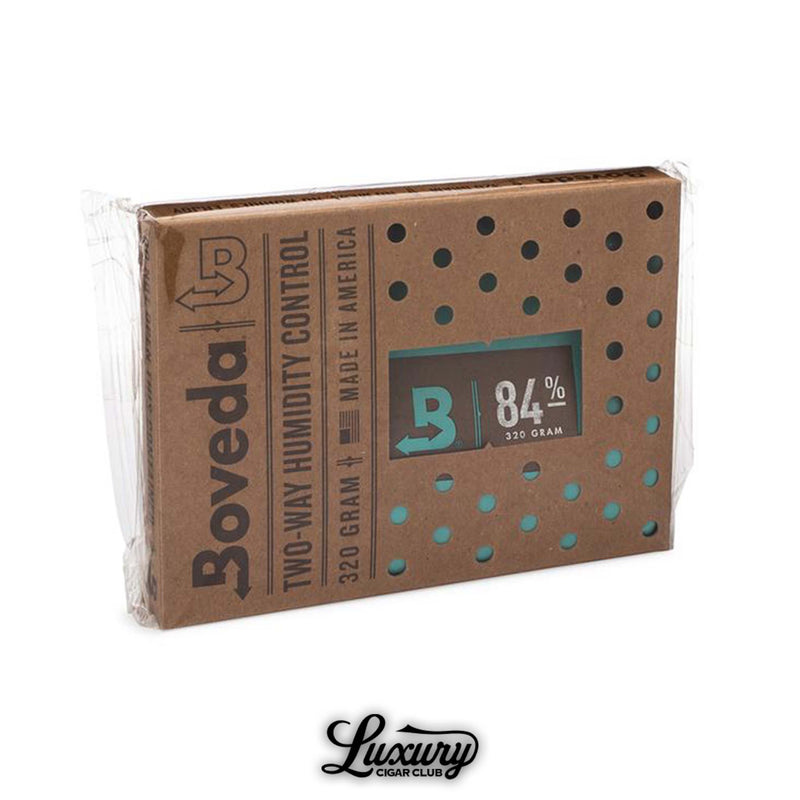Boveda 320 gram two-way humidity control pack for cigars, 84% RH level, designed for large humidors, shown in eco-friendly packaging with ventilation holes, photographed on white background with Luxury Cigar Club logo.