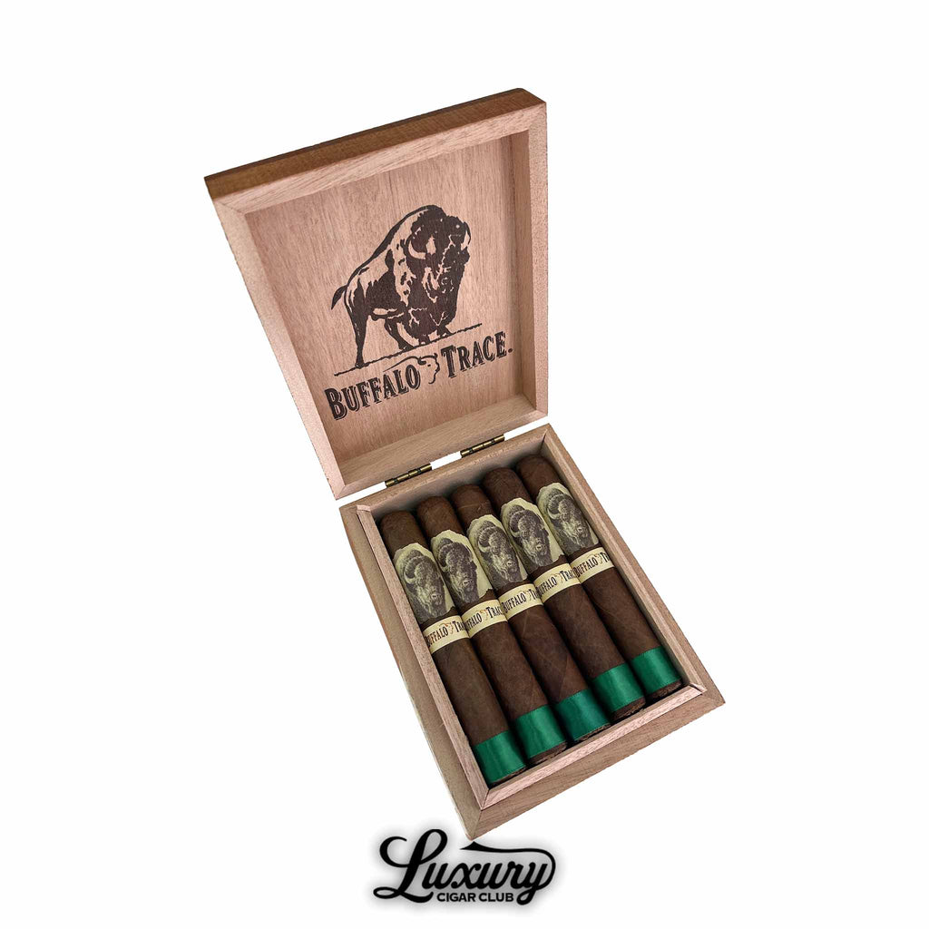 Open box of Buffalo Trace Robusto Cigars featuring green foot bands and buffalo-themed labels, displayed with branded wooden lid and Luxury Cigar Club logo