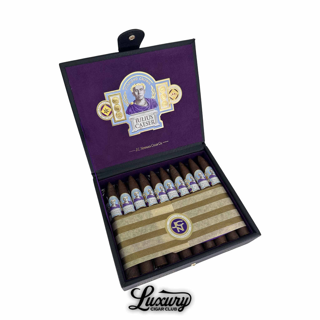 Open box of Diamond Crown Julius Caeser Pyramid Cigars with purple and gold bands, featuring a portrait of Julius Caeser on each cigar, presented by Luxury Cigar Club