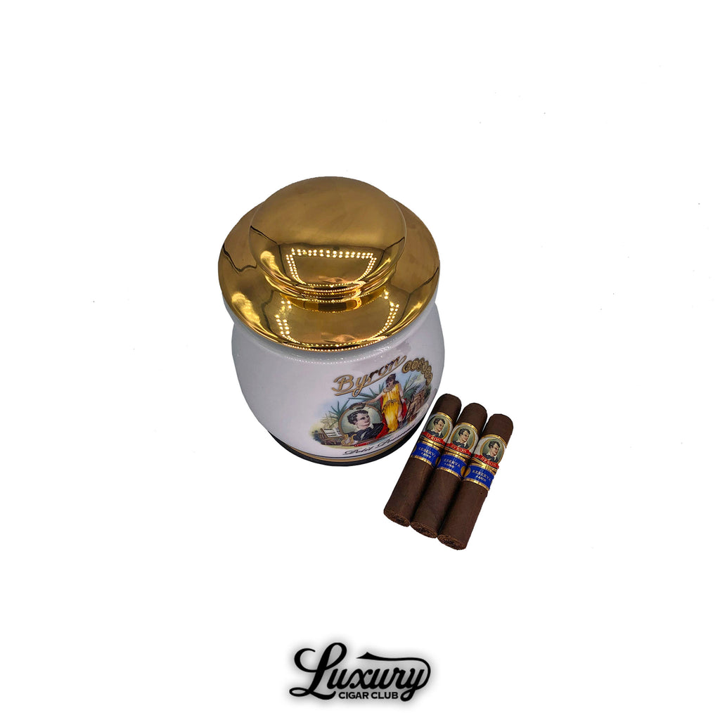 Byron 19th Century Petit Poemas cigars jar with gold lid and three premium cigars beside it, available at Luxury Cigar Club