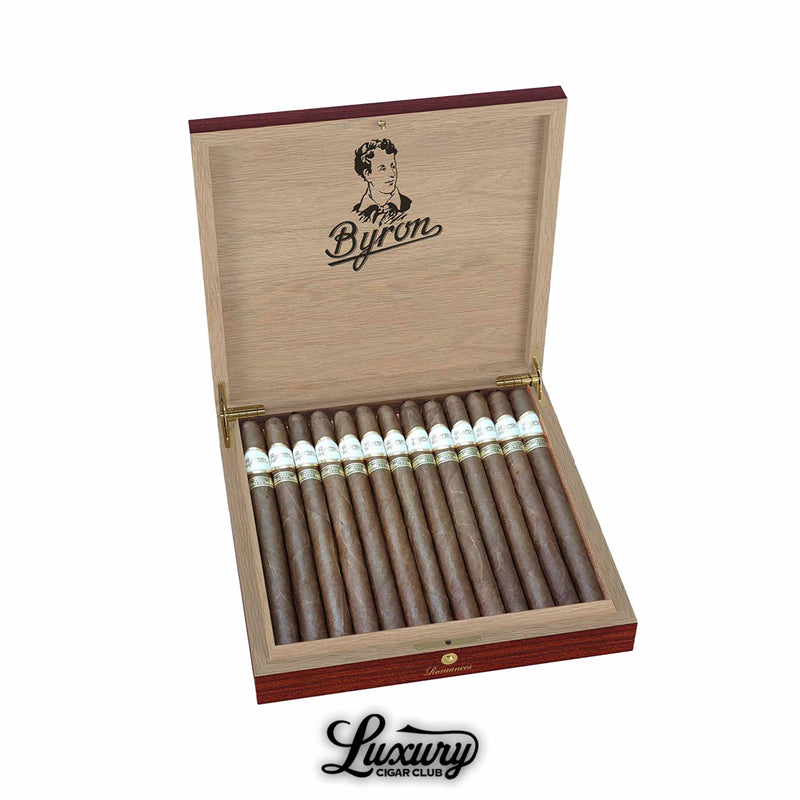 Byron Selección 1850 Selección Privada Romances cigars displayed in an elegant open box from Luxury Cigar Club showing a full row of long slender dark brown cigars with white and gold labels against a natural cedar interior