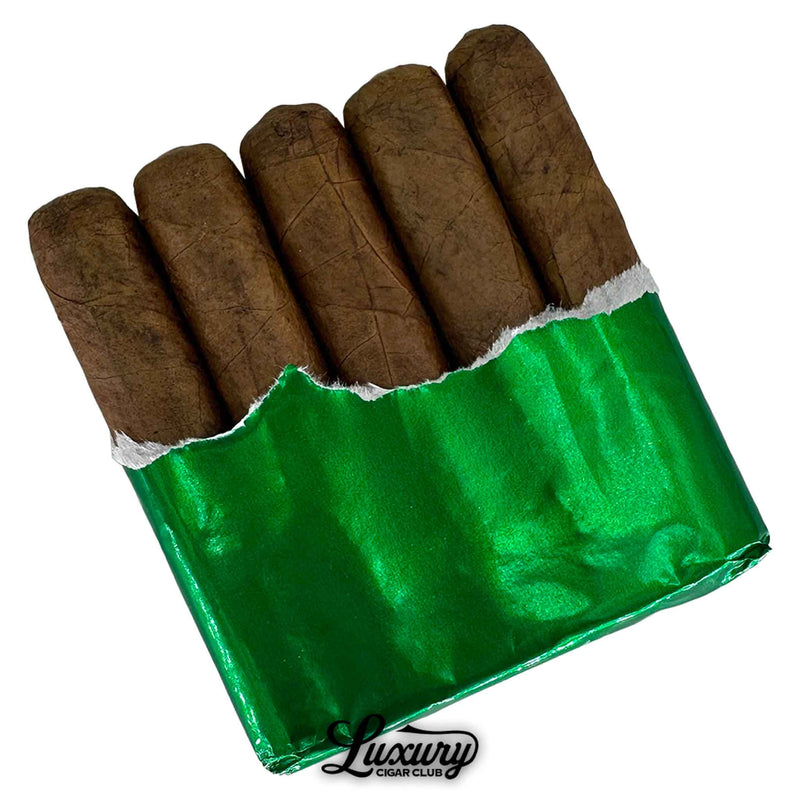 Close-up of Cabal Cajita 10th Anniversary Petite Robusto cigars partially unwrapped from shiny green foil, revealing five short, thick cigars with dark brown wrappers and the Luxury Cigar Club logo below.