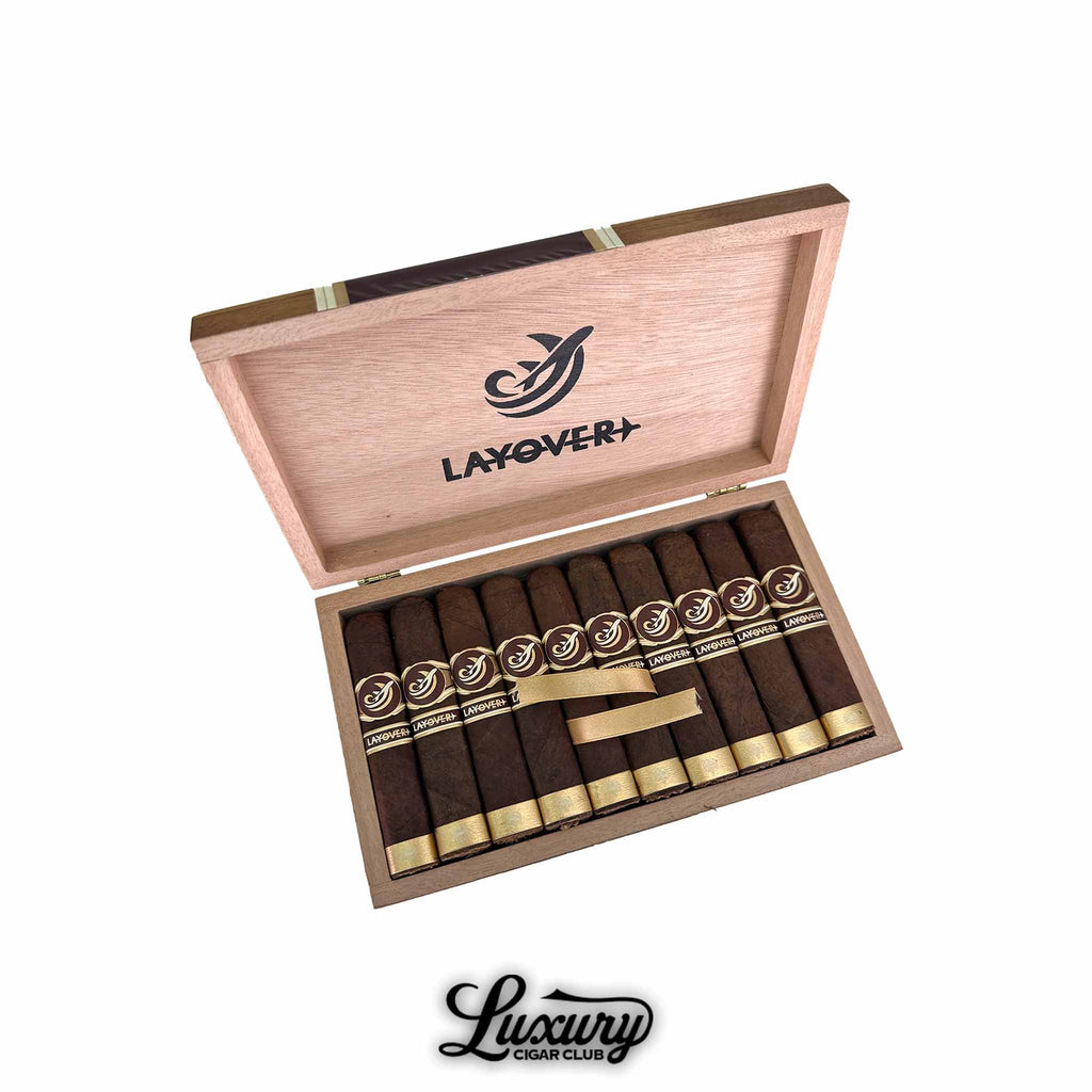 Caldwell Lost & Found The Layover box-pressed cigars neatly arranged in a natural wood box with gold and brown branding, available at Luxury Cigar Club.
