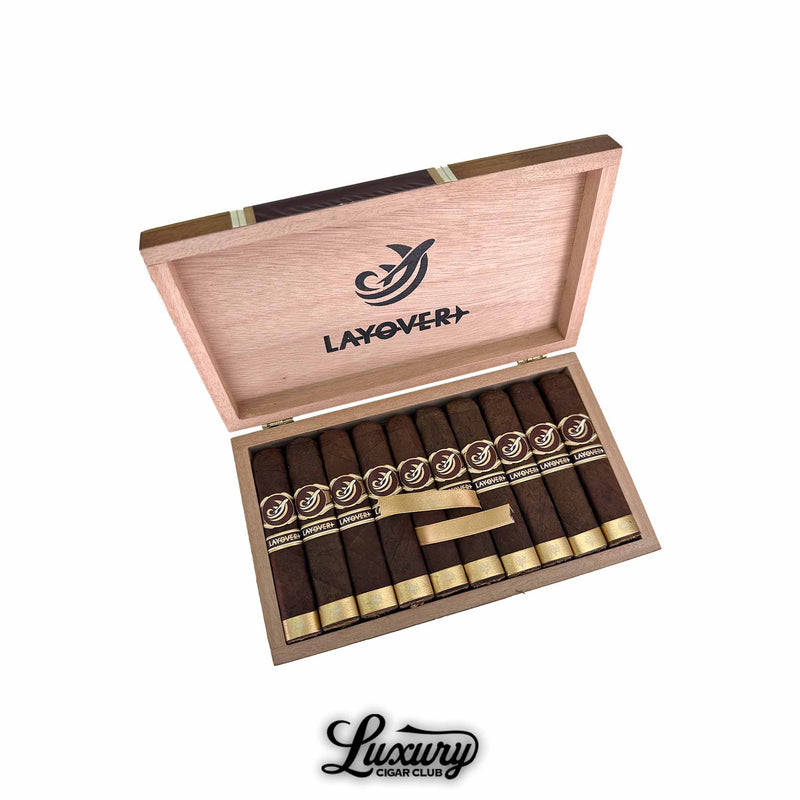 Caldwell Lost & Found The Layover box-pressed cigars neatly arranged in a natural wood box with gold and brown branding, available at Luxury Cigar Club.