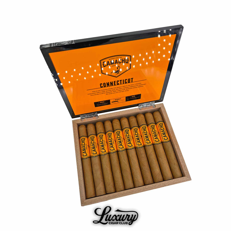 Open box of Camacho Connecticut Toro cigars featuring bold orange and black branding inside the lid. The cigars are neatly arranged with matching orange bands labeled “Camacho.” Luxury Cigar Club logo displayed below.