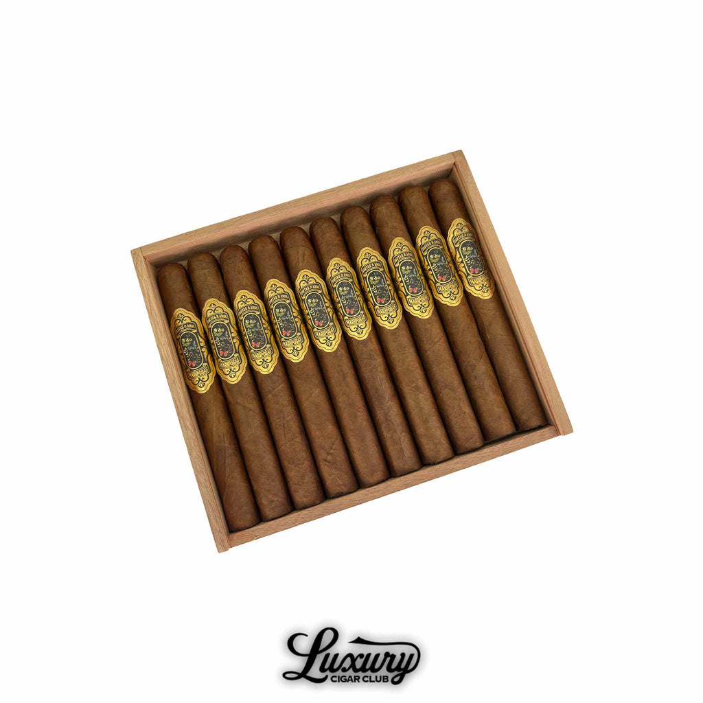 Cartas de Amor Mariposas Corona Gorda cigars arranged in an open cedar box, featuring ornate gold and black bands, from Luxury Cigar Club.