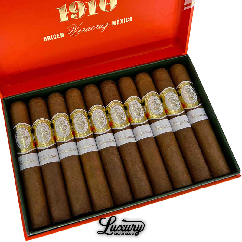 Close-up of Casa 1910 Soldadera Edition Sampetrina cigars inside a bright orange box highlighting detailed golden and white cigar bands. Luxury Cigar Club branding at the bottom.