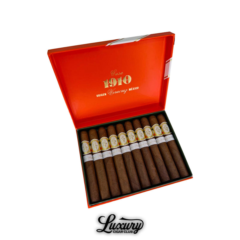 Open orange box of Casa 1910 Soldadera Edition Teniente Angela cigars from Veracruz Mexico neatly arranged with elegant gold and white bands. Luxury Cigar Club logo displayed below.