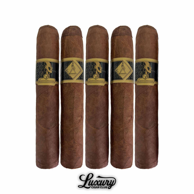 Five Casdagli The Blockchain Smokers Wide Churchill cigars from Luxury Cigar Club arranged upright, featuring smooth reddish-brown wrappers and black-and-gold bands with geometric and profile artwork.