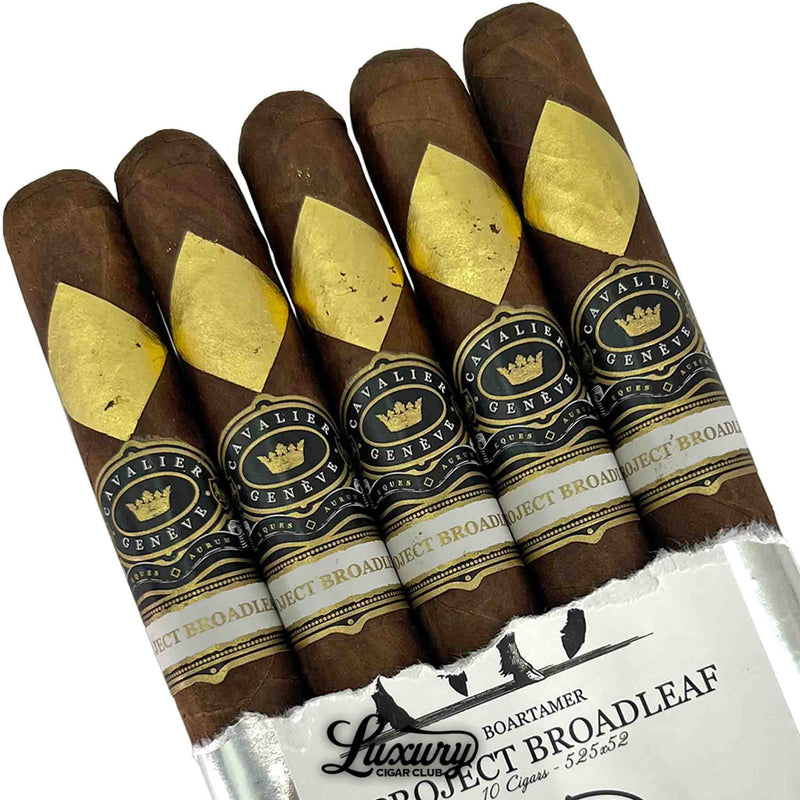 Close-up of Cavalier Genève Project Broadleaf Boartamer cigars showing signature gold diamond foil and black bands, premium boutique cigars available at Luxury Cigar Club.