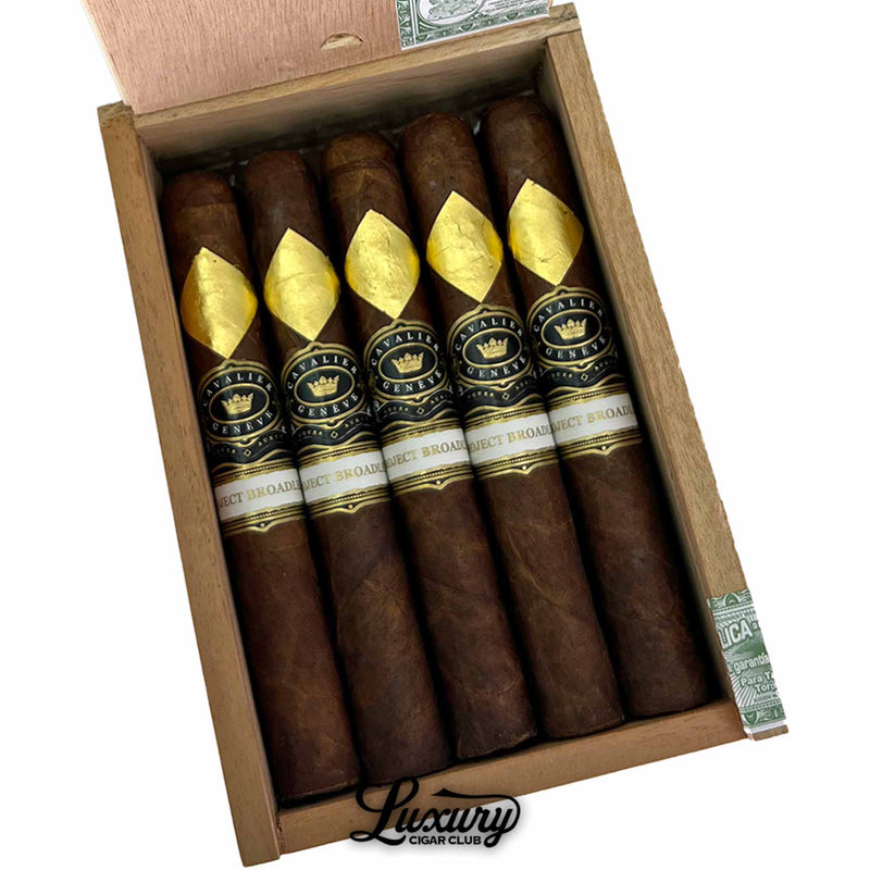 Close-up of Cavalier Genève Project Broadleaf Wayfinders Robusto Extra cigars in their box, highlighting the gold leaf emblem and refined band design, presented by Luxury Cigar Club.