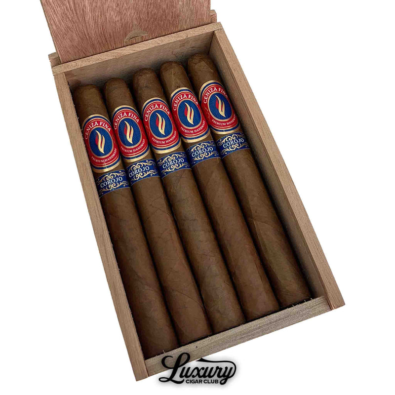Close-up of five Ceniza Fina Corojo Corona cigars neatly arranged in an open wooden box, showcasing red, blue, and gold bands with Luxury Cigar Club logo at the bottom