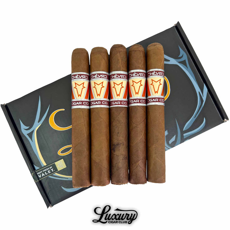 Close-up of five Chèvre Dystopian Orange Toro cigars arranged across the LCC box, by Luxury Cigar Club.
