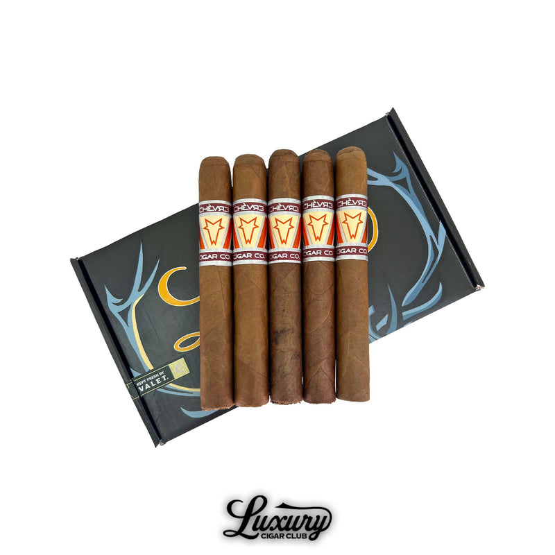 Five Chèvre Dystopian Orange Toro cigars displayed on top of the branded LCC box, by Luxury Cigar Club.