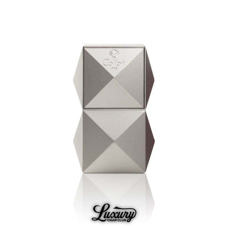 Colibri Quasar tabletop triple flame lighter in silver with geometric pyramid design and Colibri 1928 logo sold by Luxury Cigar Club
