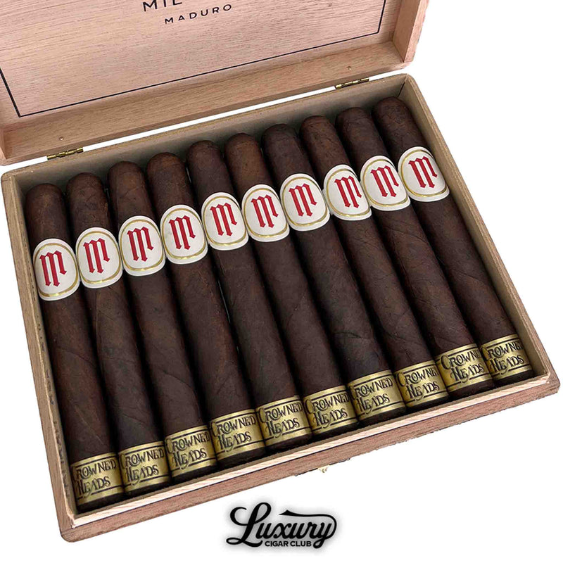 close-up box of Crowned Heads Mil Días Maduro Sublime cigars with dark wrappers and gold bands, Luxury Cigar Club.