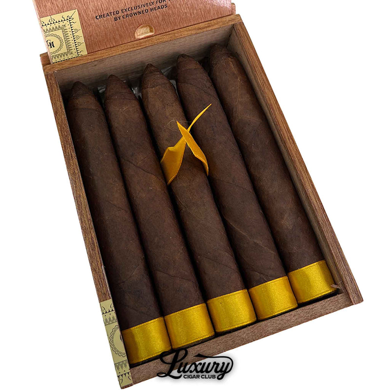Close-up of Crowned Heads Yellow Rose Torpedo cigars inside an open box highlighting dark maduro wrapper leaf, torpedo capped heads, and gold foot ribbon presentation, featured luxury cigars available from Luxury Cigar Club