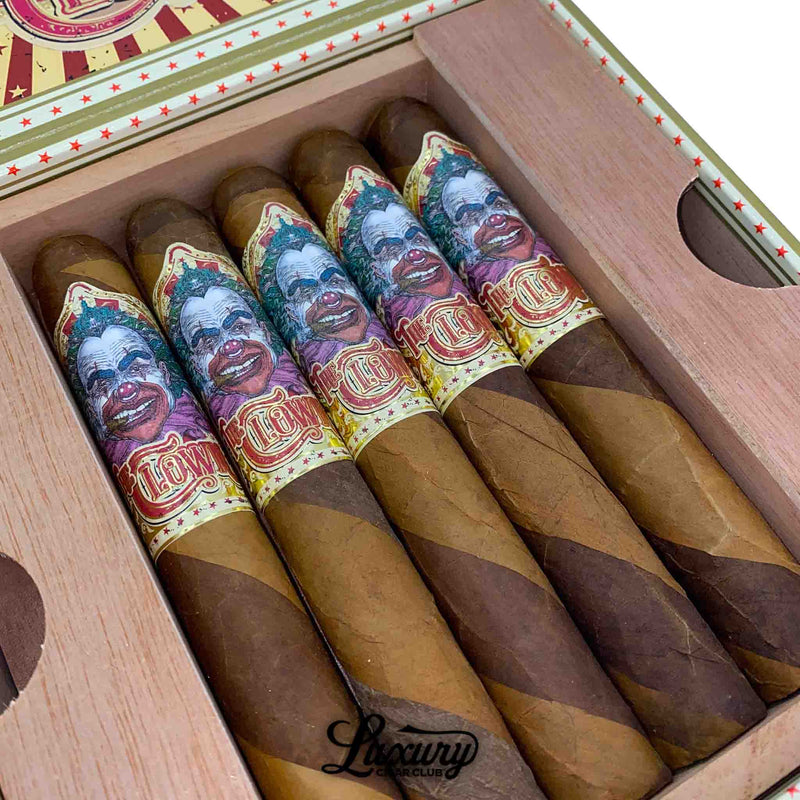 Close-up of Danli Honduras Tobacco The Clown Corojo Barber Pole cigars showcasing the dual-shade barber pole wrappers and vibrant clown-themed bands, featured by Luxury Cigar Club.