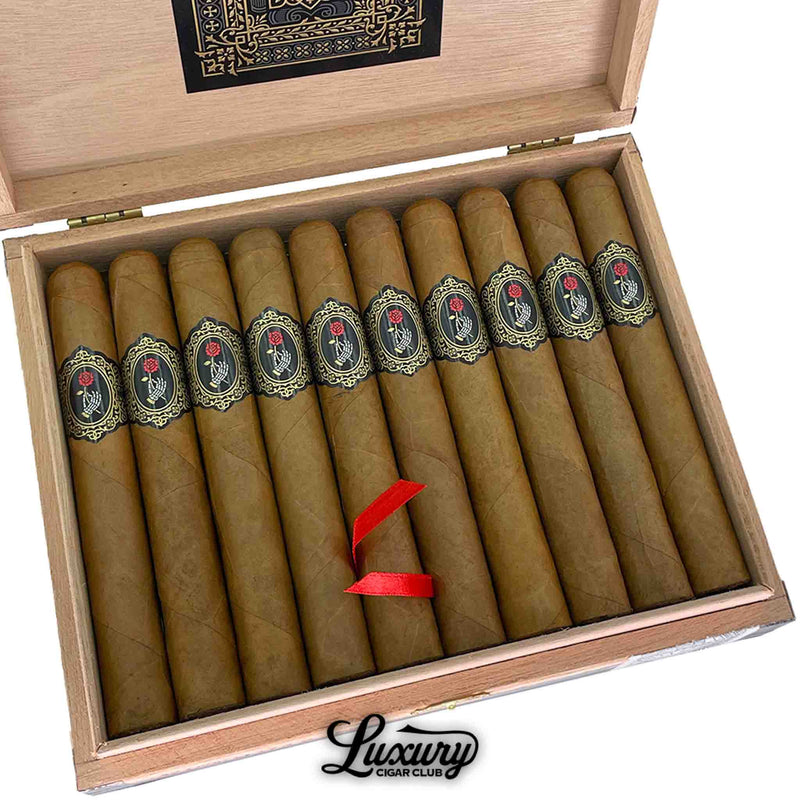 Close-up of Dapper La Madrina Shade Toro cigars arranged inside a wooden box, highlighting the smooth Connecticut shade wrappers and detailed black and gold bands with a red rose design. The luxurious presentation and fine construction embody the brand’s dedication to quality. Luxury Cigar Club.