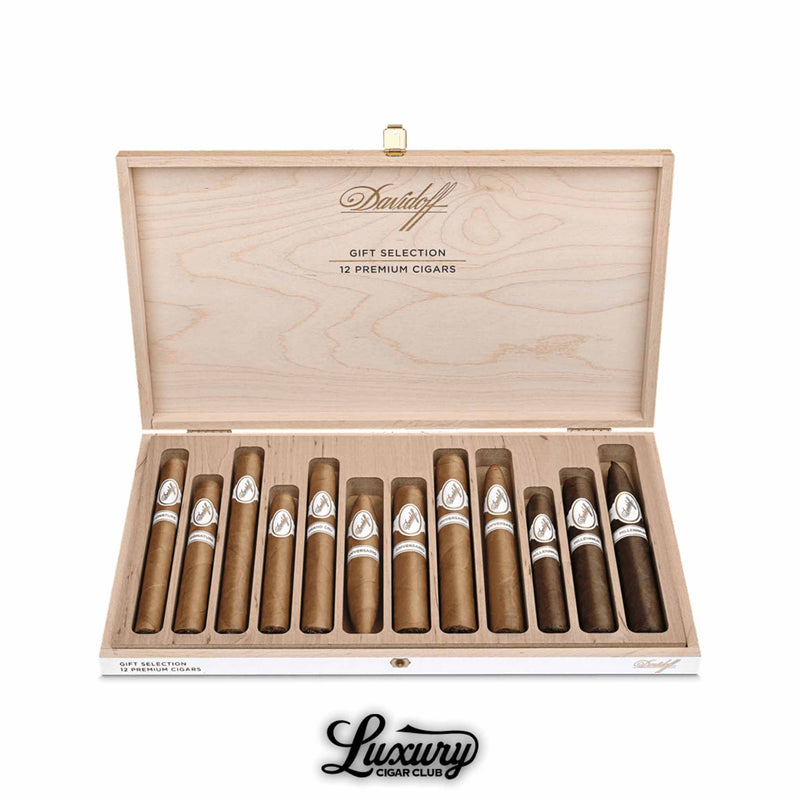 Open wooden Davidoff 12-cigar premium gift selection box displayed by Luxury Cigar Club, featuring an assortment of Davidoff white-band cigars arranged in individual slots with natural wood interior and elegant presentation.