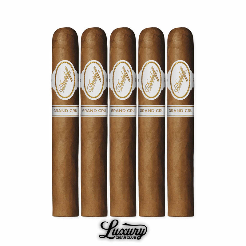 Five Davidoff Grand Cru Toro cigars standing upright, golden brown Ecuadorian wrapper with white and gold Davidoff bands labeled “Grand Cru,” presented with the Luxury Cigar Club logo.