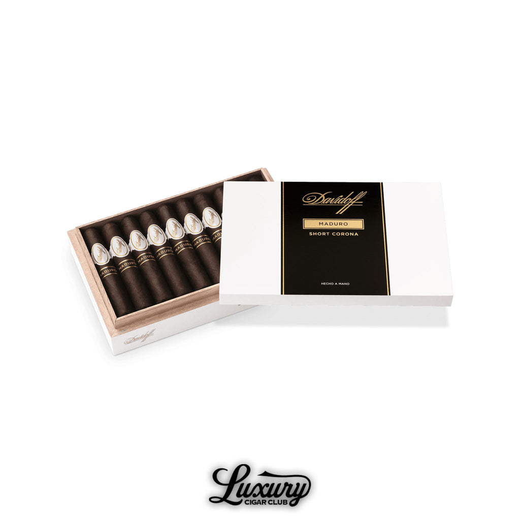 Open white Davidoff Maduro Short Corona box with dark Maduro-wrapped cigars neatly arranged, black and gold lid design, labeled “Hecho a Mano,” displayed for Luxury Cigar Club.